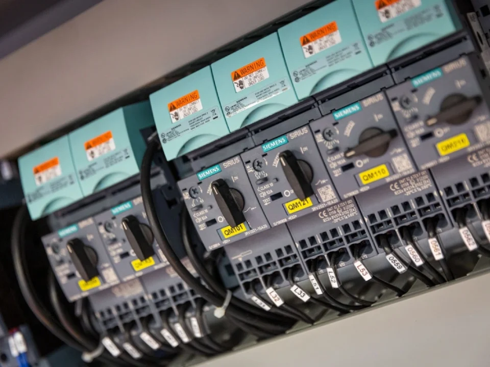 Close-up of a Siemens Sirius motor protection circuit breaker bank inside a control panel.